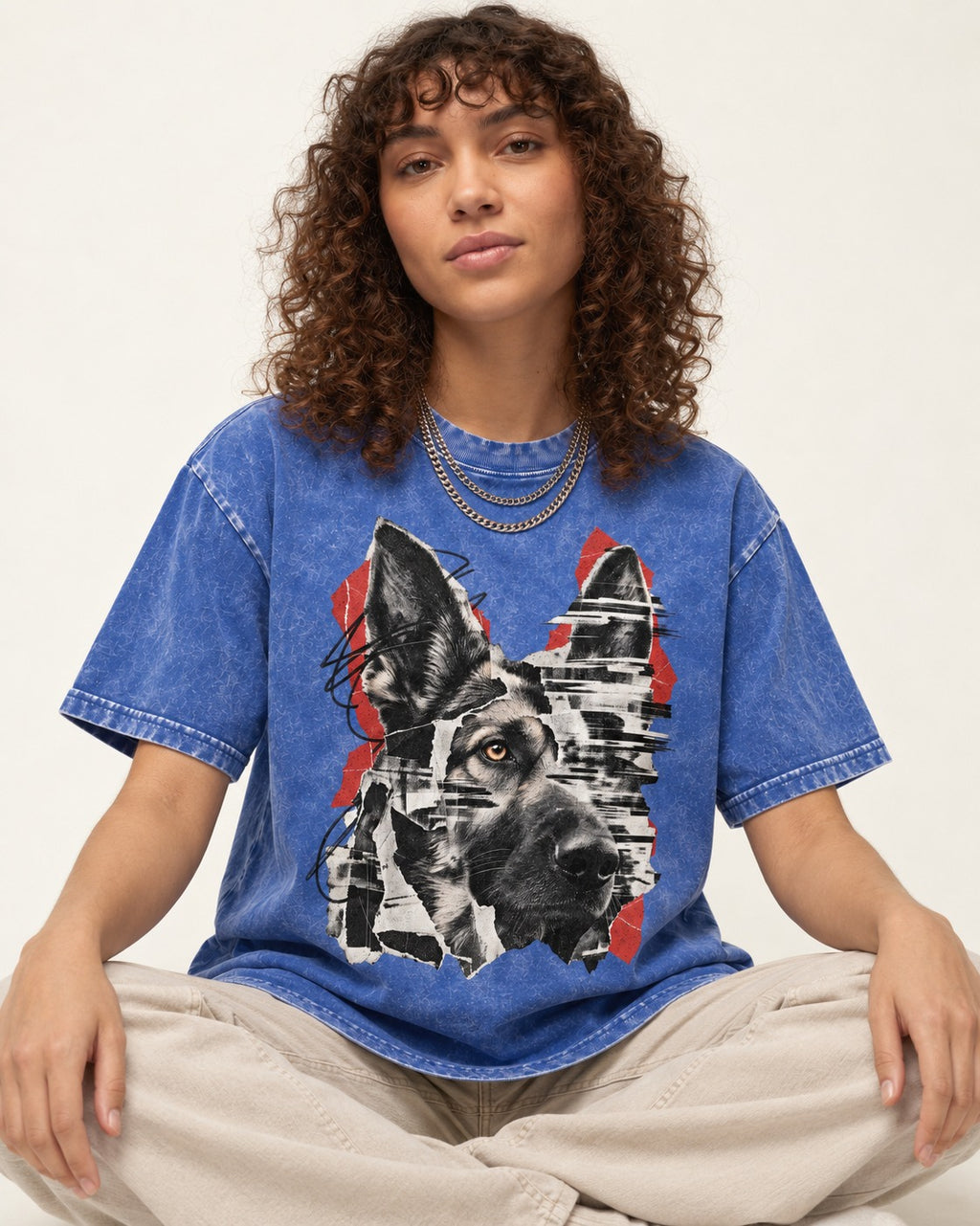 Black Signal Torn Collage German Shepherd Dog Portrait Graphic Washed Tee in Royal Blue, worn by a seated model