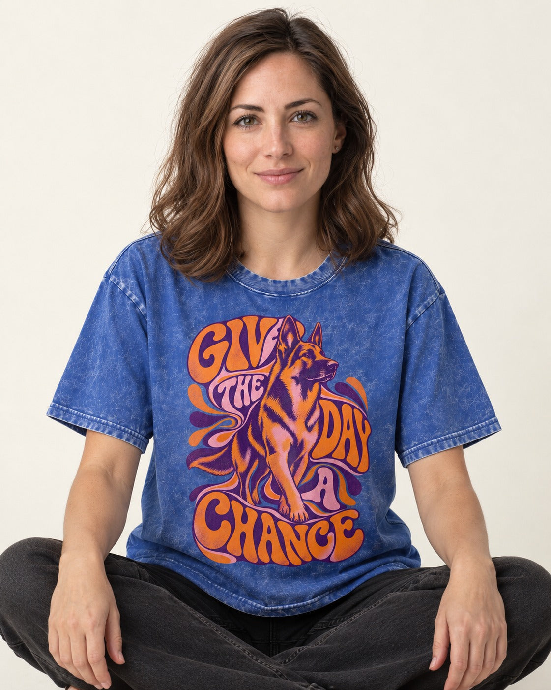 Give The Day A Chance Psychedelic German Shepherd Dog Graphic Washed Tee in Royal Blue, worn by a seated model