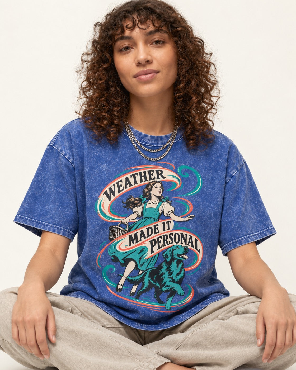 Golden Retriever Weather Made It Personal Woman Graphic Washed Tee in Royal Blue, worn by a seated model
