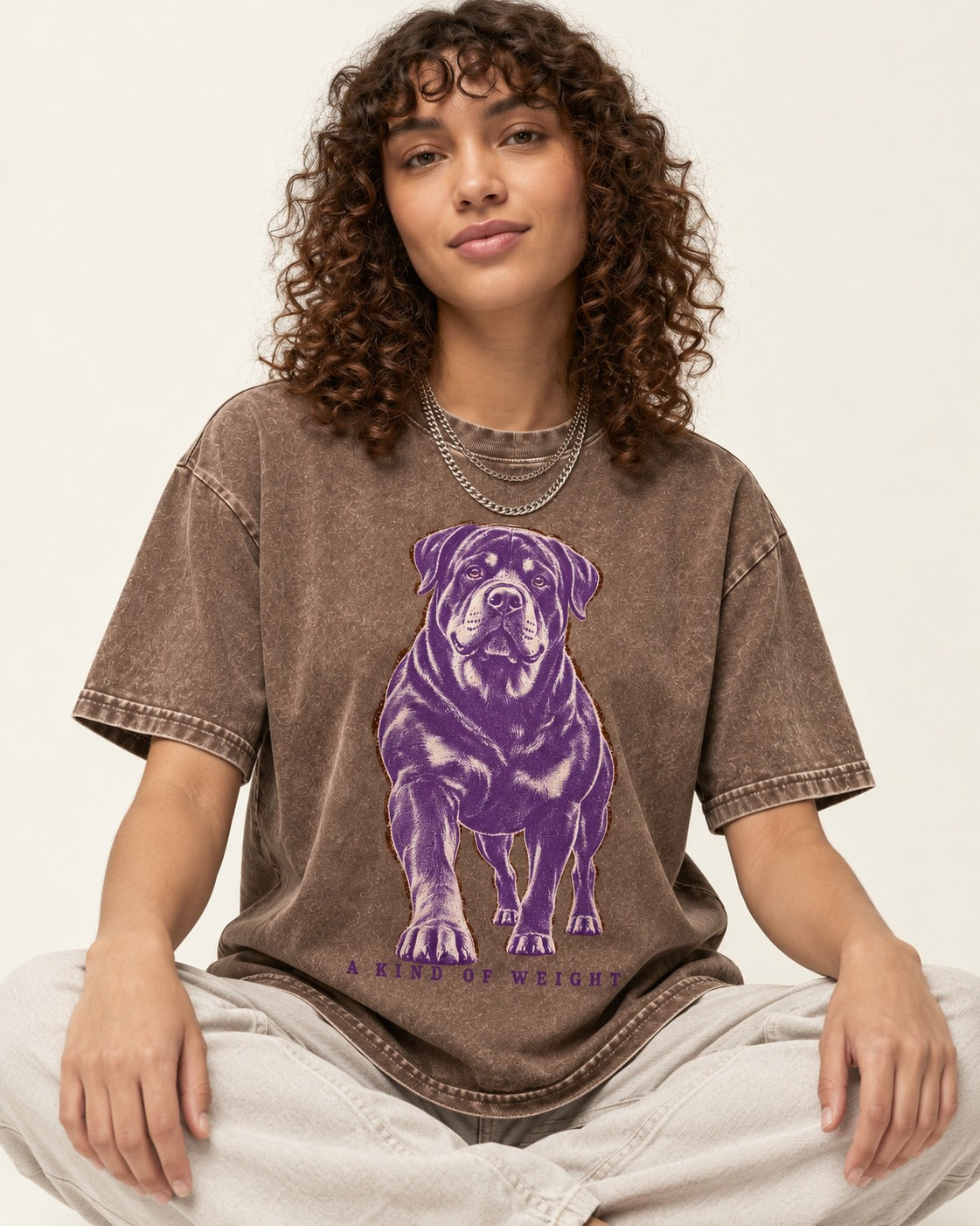 Rottweiler A Kind of Weight Washed Tee in Coffee, worn by a seated model
