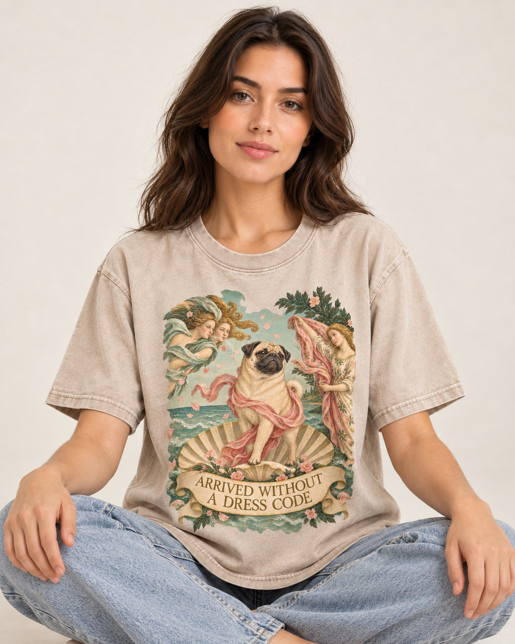 Pug Arrived Without a Dress Code Venus Parody Graphic Washed Tee in Apricot, worn by a seated model
