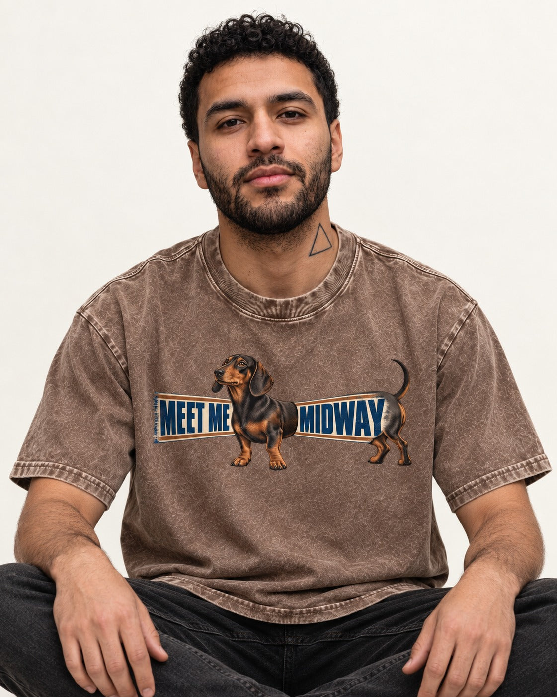 Dachshund Meet Me Midway Washed Tee in Coffee, worn by a seated model