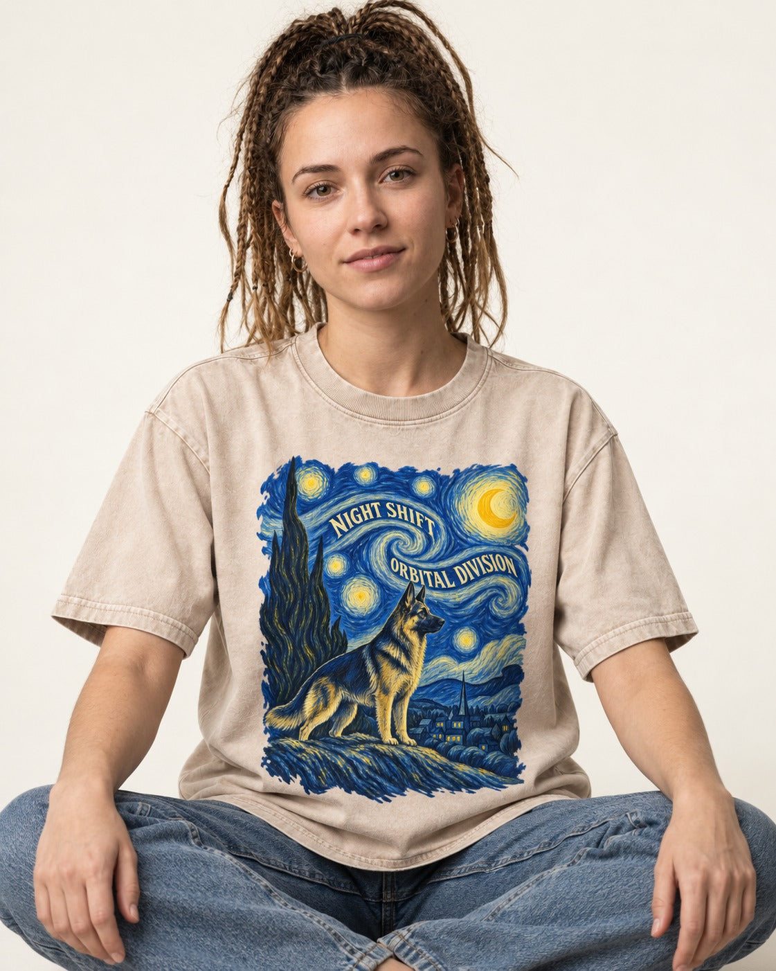 German Shepherd Dog Night Shift Orbital Division Starry Night Washed Tee in Apricot, worn by a seated model