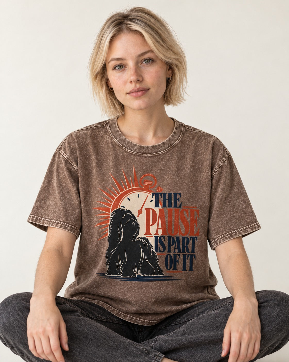 The Shih Tzu Pause Washed Tee in Coffee, worn by a seated model