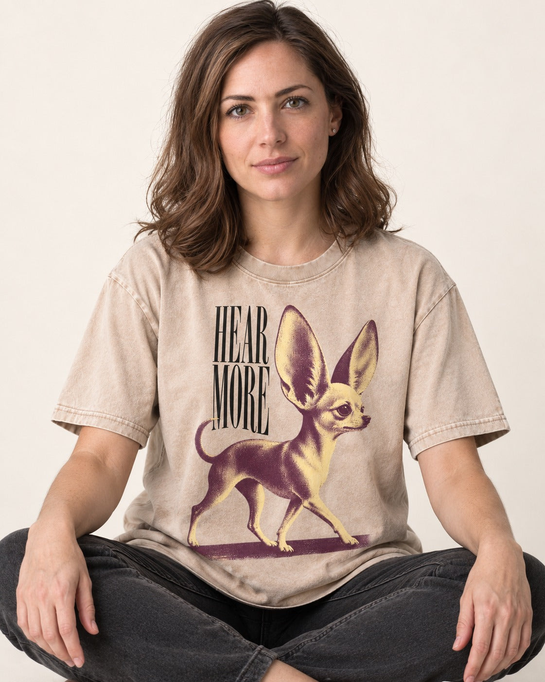 Hear More Chihuahua Washed Tee in Apricot, worn by a seated model