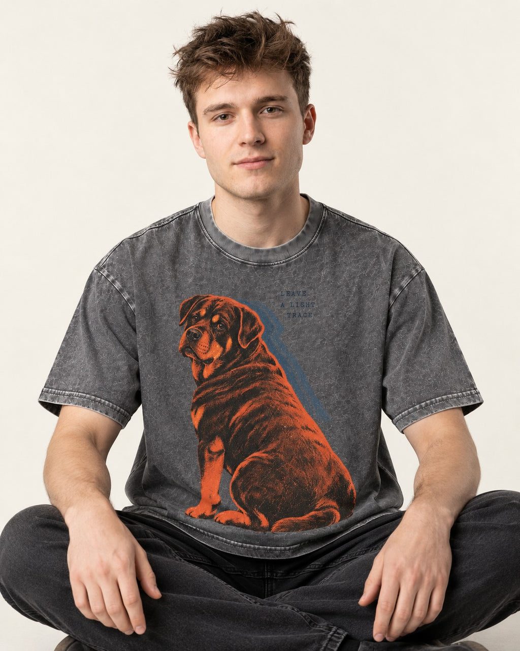 Rottweiler Leave a Light Trace Washed Tee in Gray, worn by a seated model