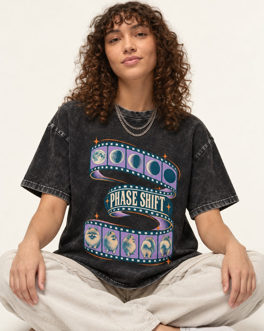 Pomeranian Phase Shift Filmstrip Graphic Washed Tee in Black, worn by a seated model