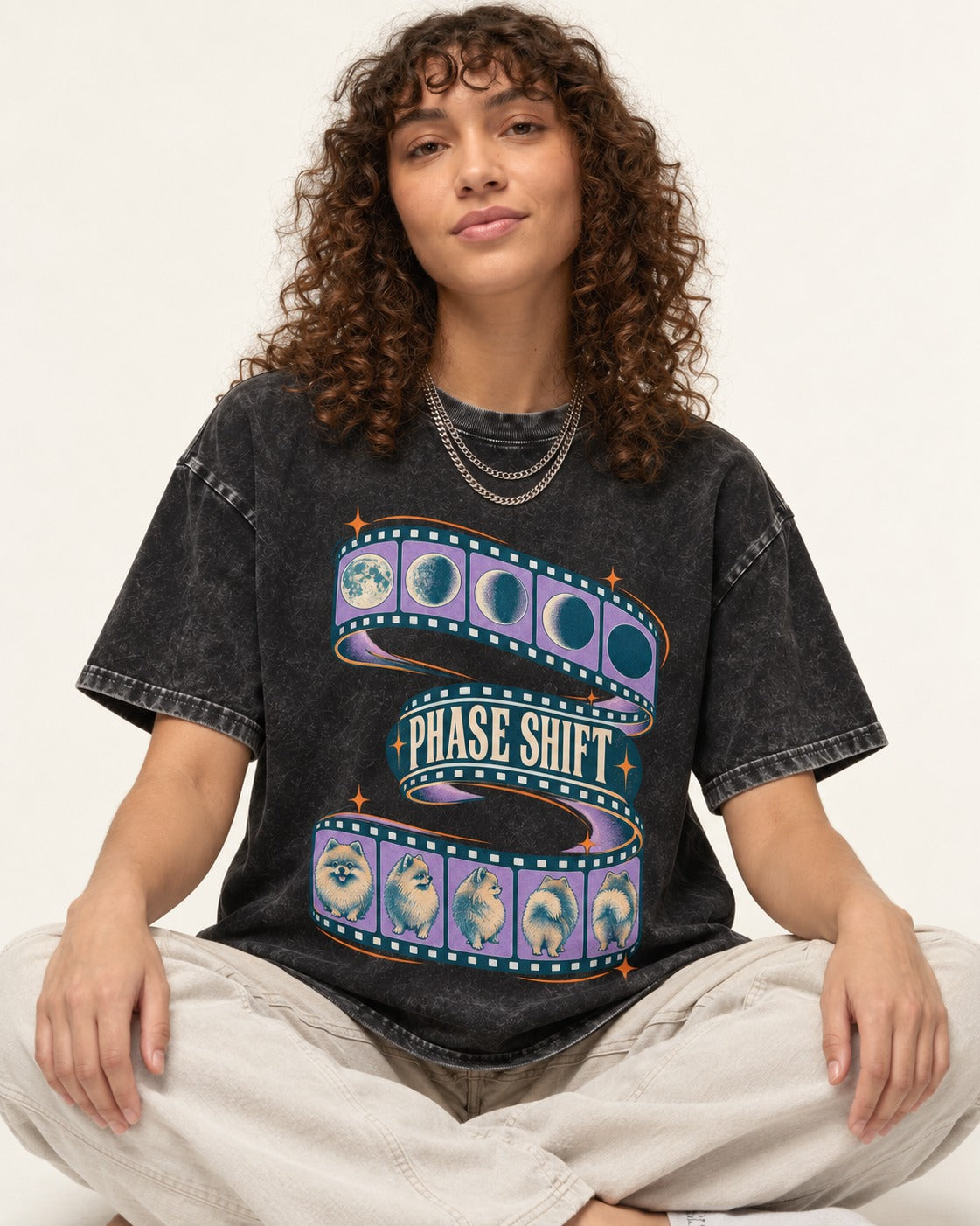 Pomeranian Phase Shift Filmstrip Graphic Washed Tee in Black, worn by a seated model