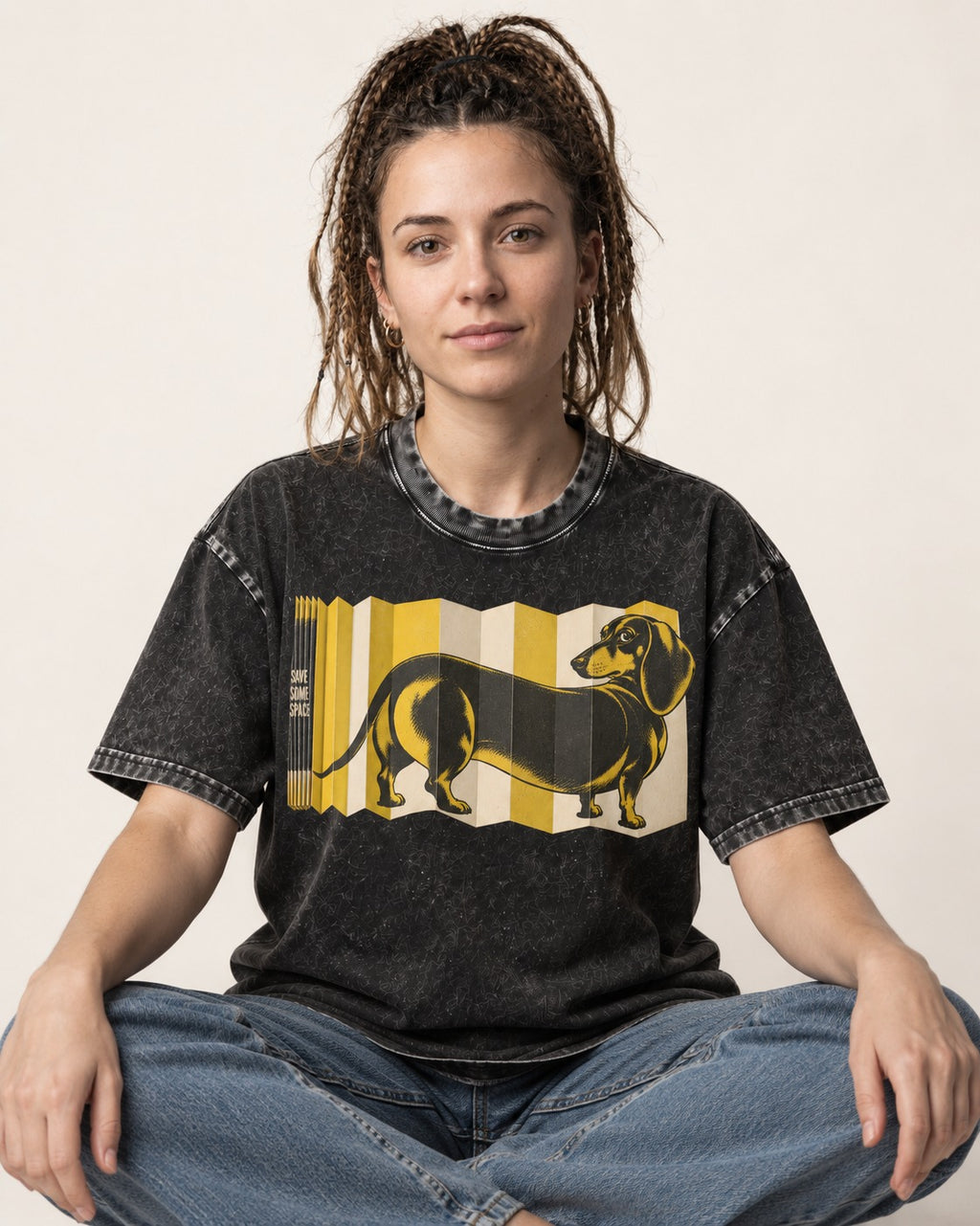 Dachshund Save Some Space Accordion Screen Graphic Washed Tee in Black, worn by a seated model