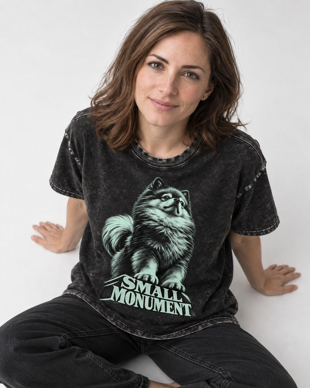 Pomeranian Small Monument Pedestal Graphic Washed Tee in Black, worn by a seated model