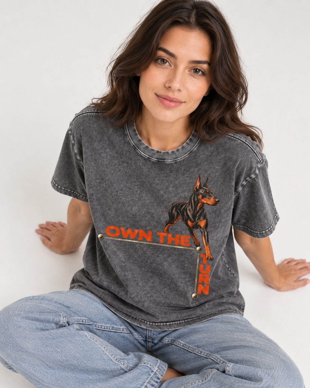 Own the Turn Doberman Washed Tee in Gray, worn by a seated model