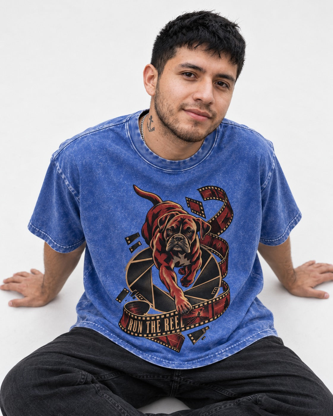 Run the Reel Boxer Film Graphic Washed Tee in Royal Blue, worn by a seated model