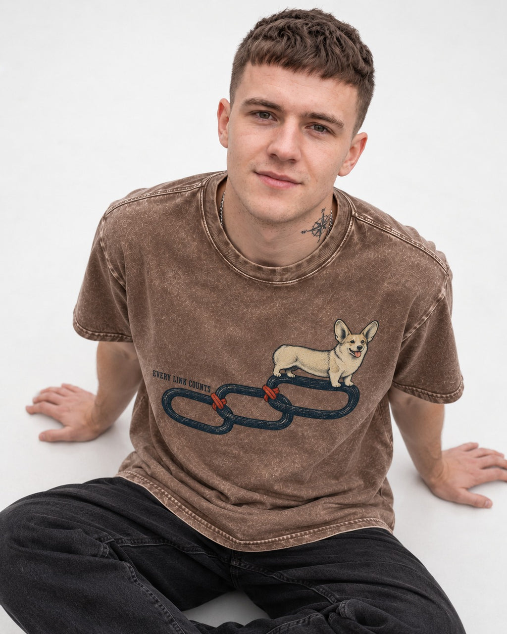 Every Corgi Link Counts Washed Tee in Coffee, worn by a seated model