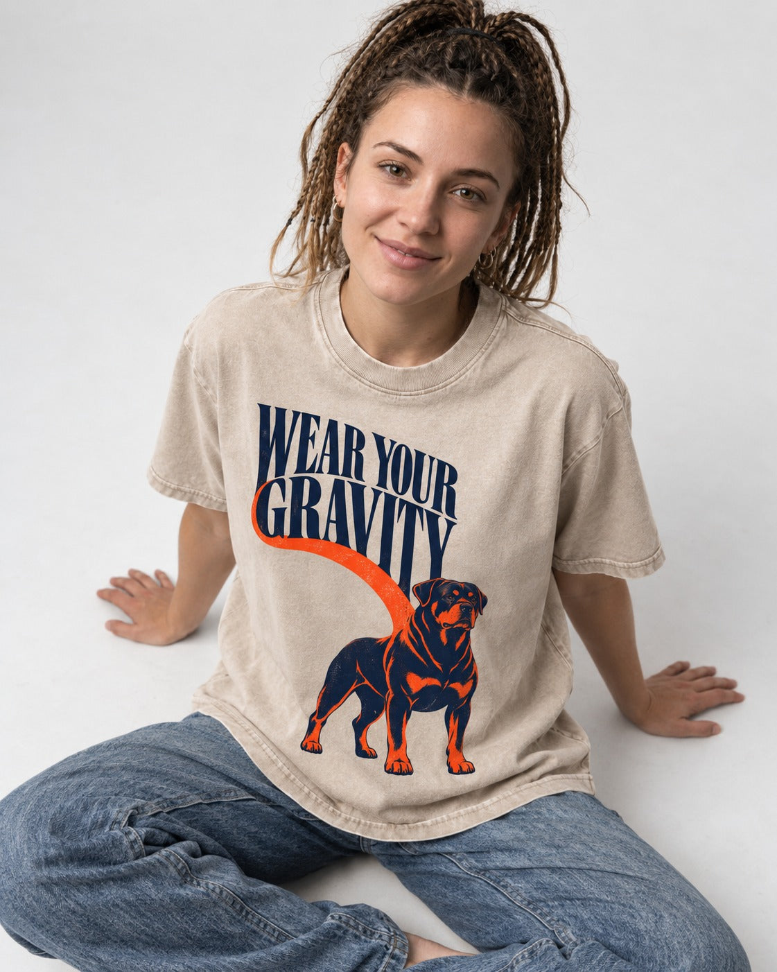 Wear Your Gravity Rottweiler Washed Tee in Apricot, worn by a seated model
