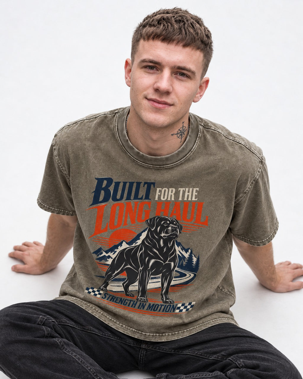 Built for the Long Haul Rottweiler Strength in Motion Washed Tee in Army Green, worn by a seated model