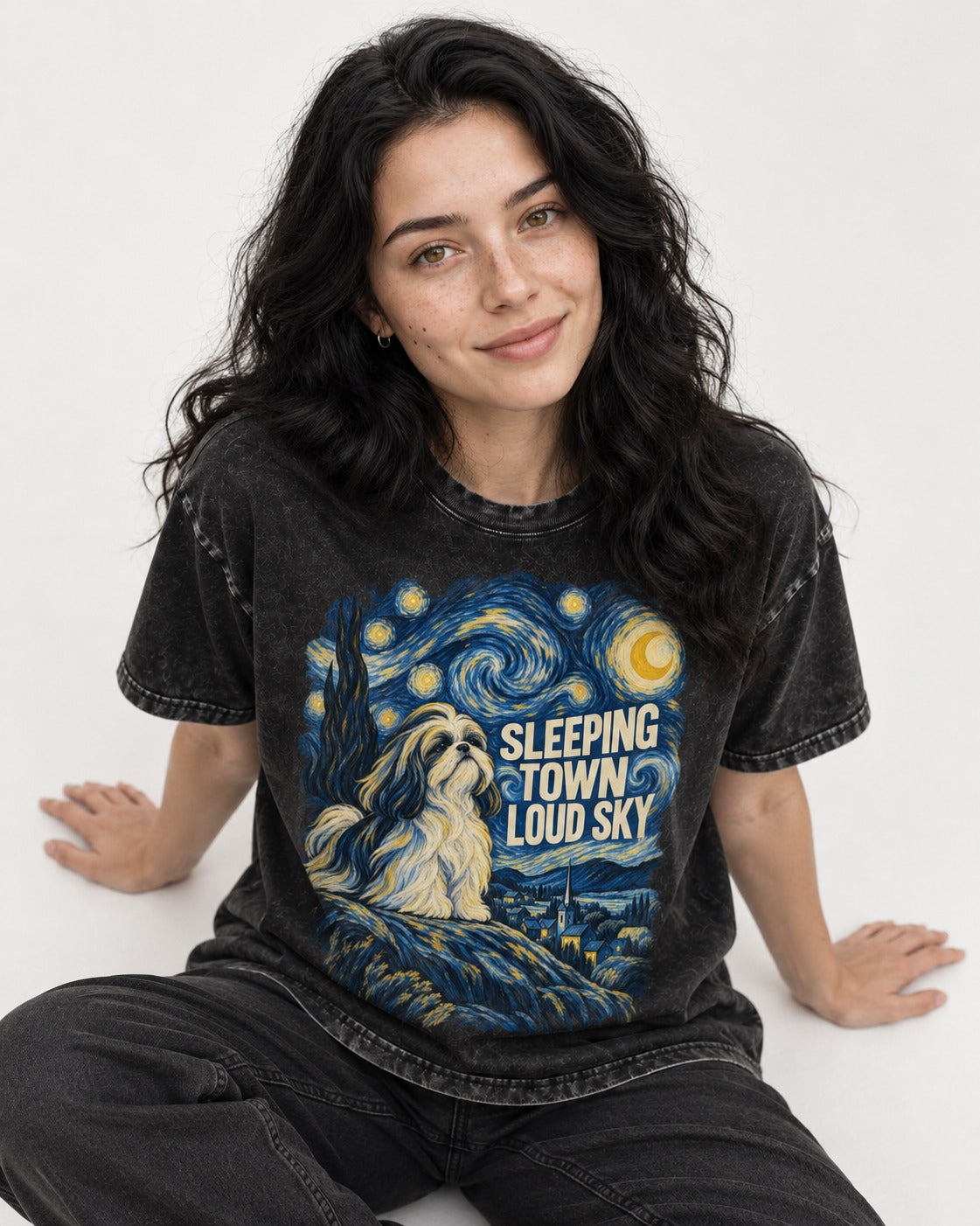 Shih Tzu Sleeping Town Loud Sky Swirling Night Graphic Washed Tee in Black, worn by a seated model