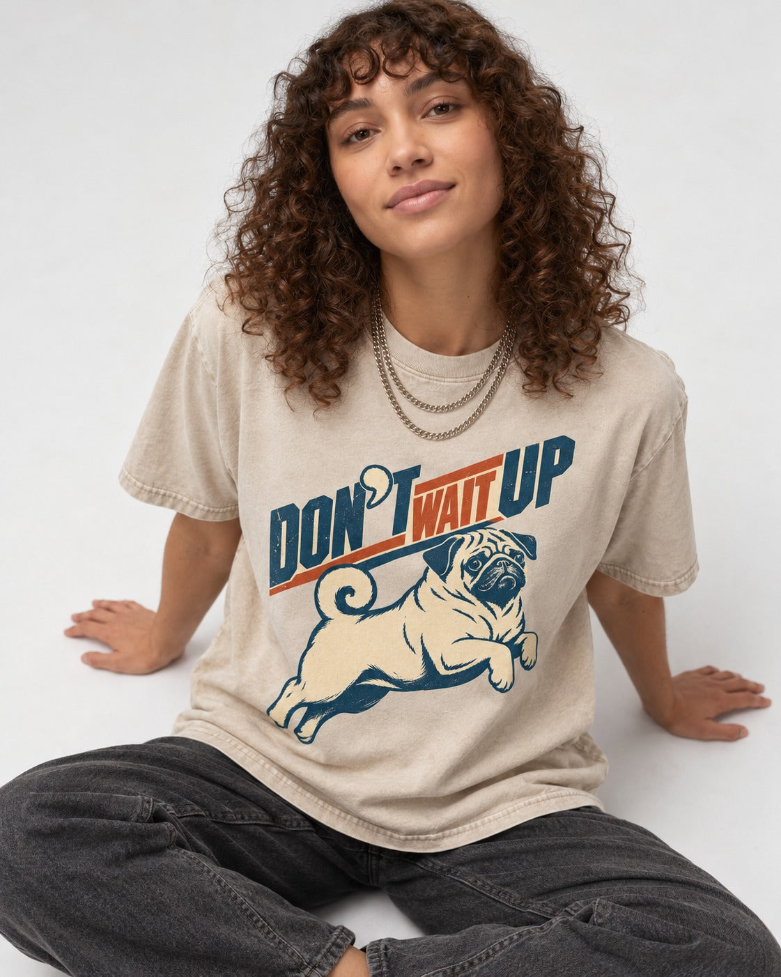 Don't Wait Up for Pug Washed Tee in Apricot, worn by a seated model