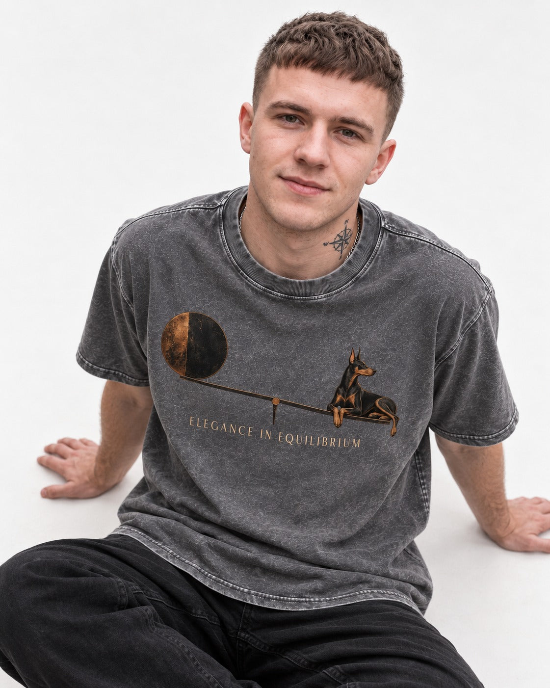 Doberman Elegance in Equilibrium Balance Graphic Washed Tee in Gray, worn by a seated model