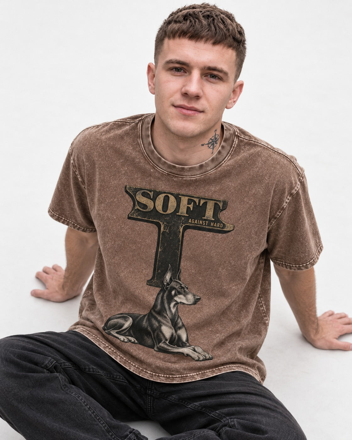 Soft Against Hard Doberman Washed Tee in Coffee, worn by a seated model