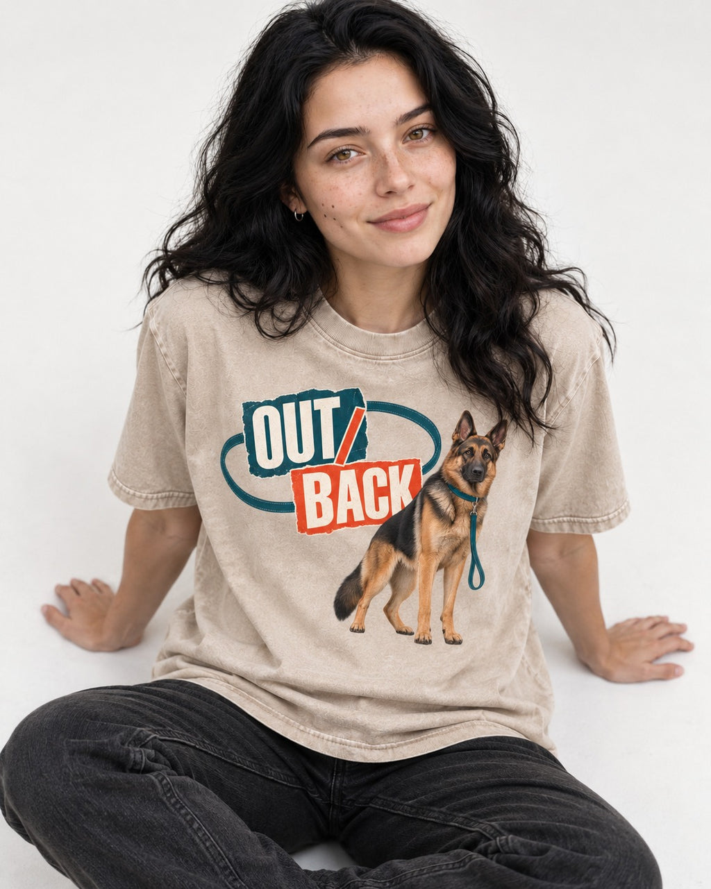 Out Back Leash German Shepherd Dog Graphic Washed Tee in Apricot, worn by a seated model