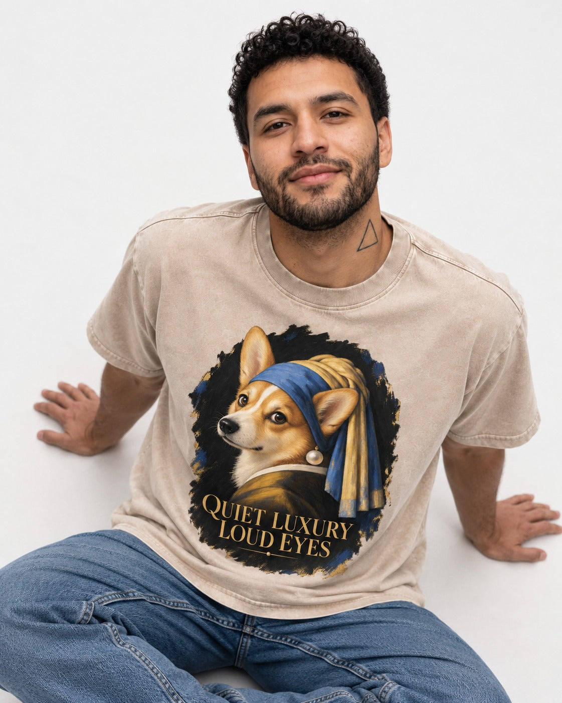 Corgi Quiet Luxury Loud Eyes Pearl Earring Portrait Washed Tee in Apricot, worn by a seated model