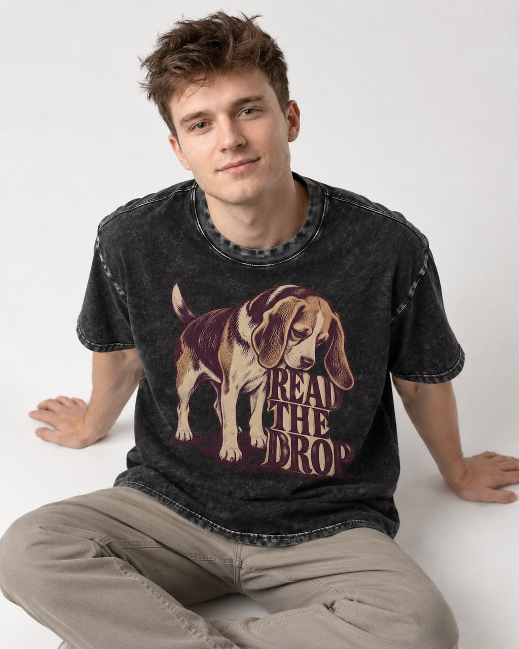 Beagle Read The Drop Washed Tee in Black, worn by a seated model