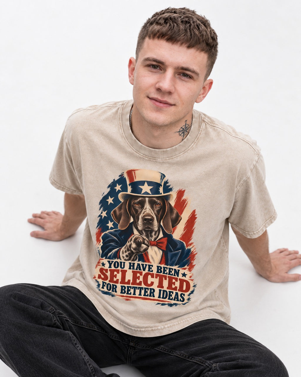 German Shorthaired Pointer You Have Been Selected For Better Ideas Uncle Sam Graphic Washed Tee in Apricot, worn by a seated model