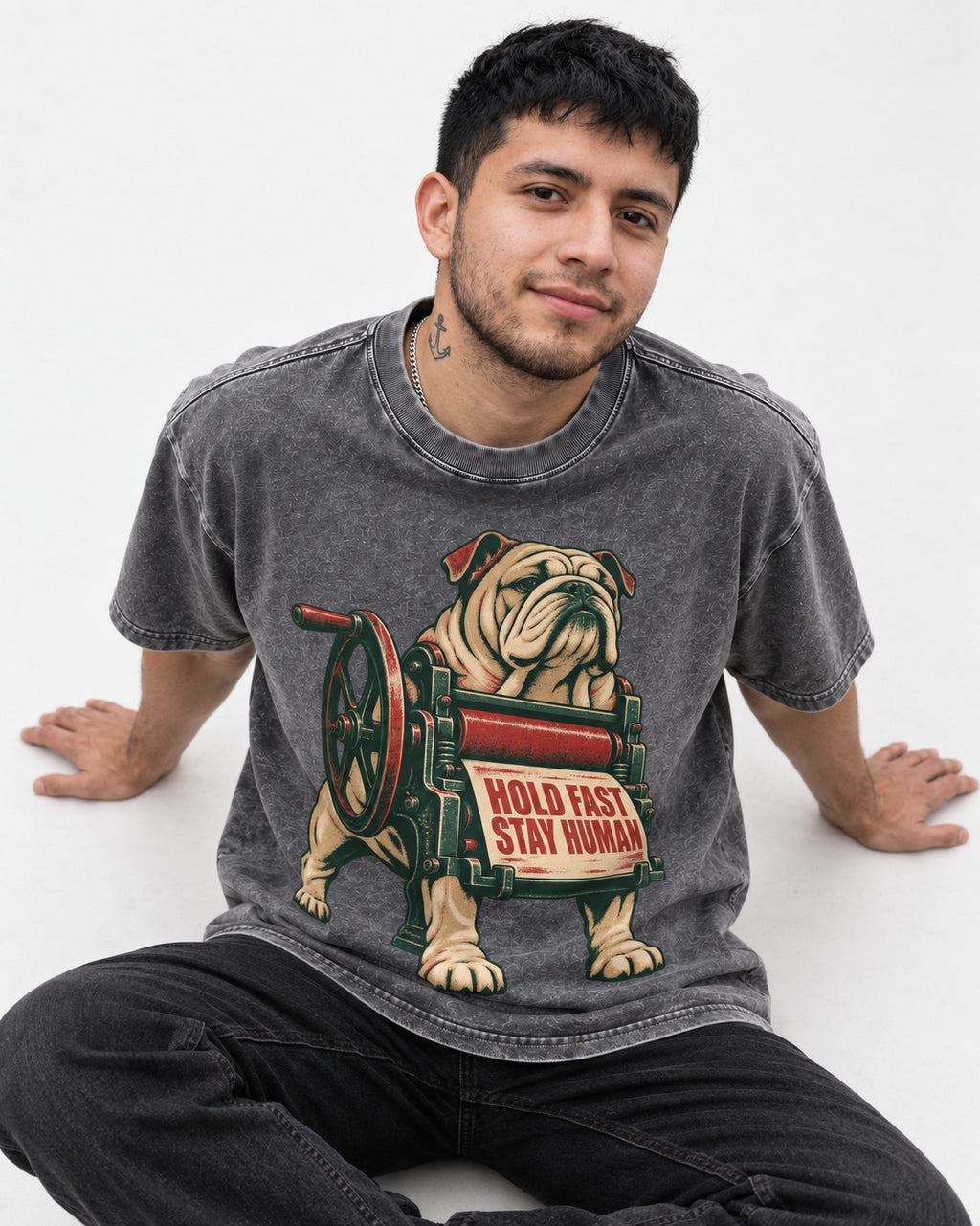 Hold Fast Stay Human English Bulldog Washed Tee in Gray, worn by a seated model