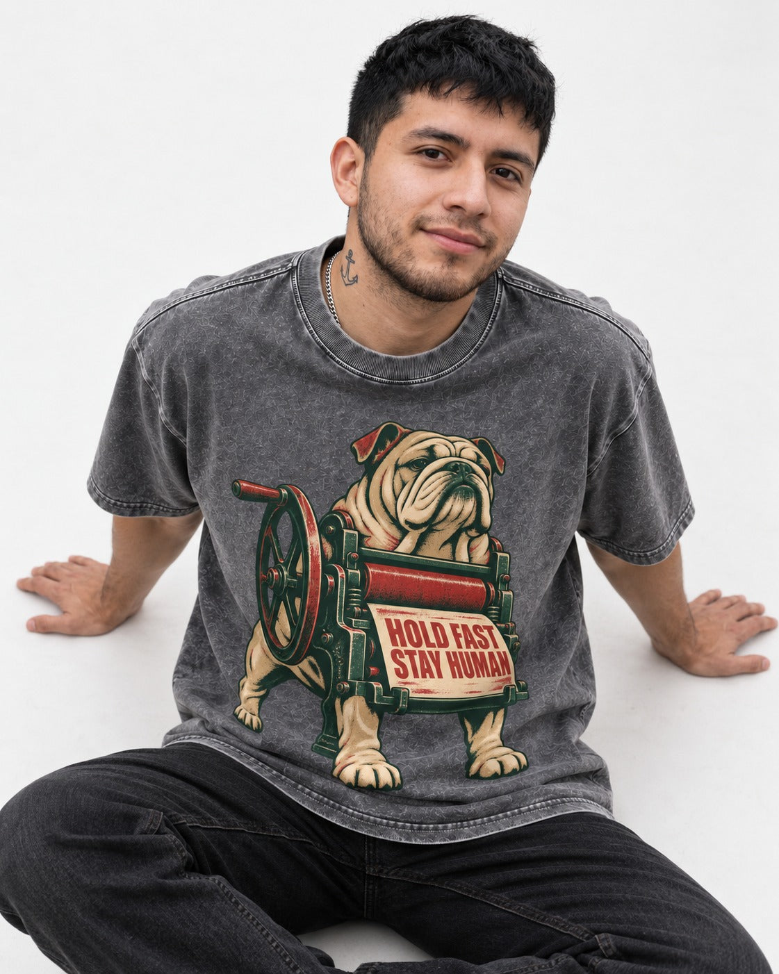 Hold Fast Stay Human English Bulldog Washed Tee in Gray, worn by a seated model