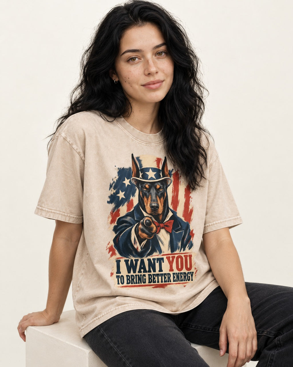 Doberman I Want You to Bring Better Energy Uncle Sam Graphic Washed Tee in Apricot, worn by a seated model