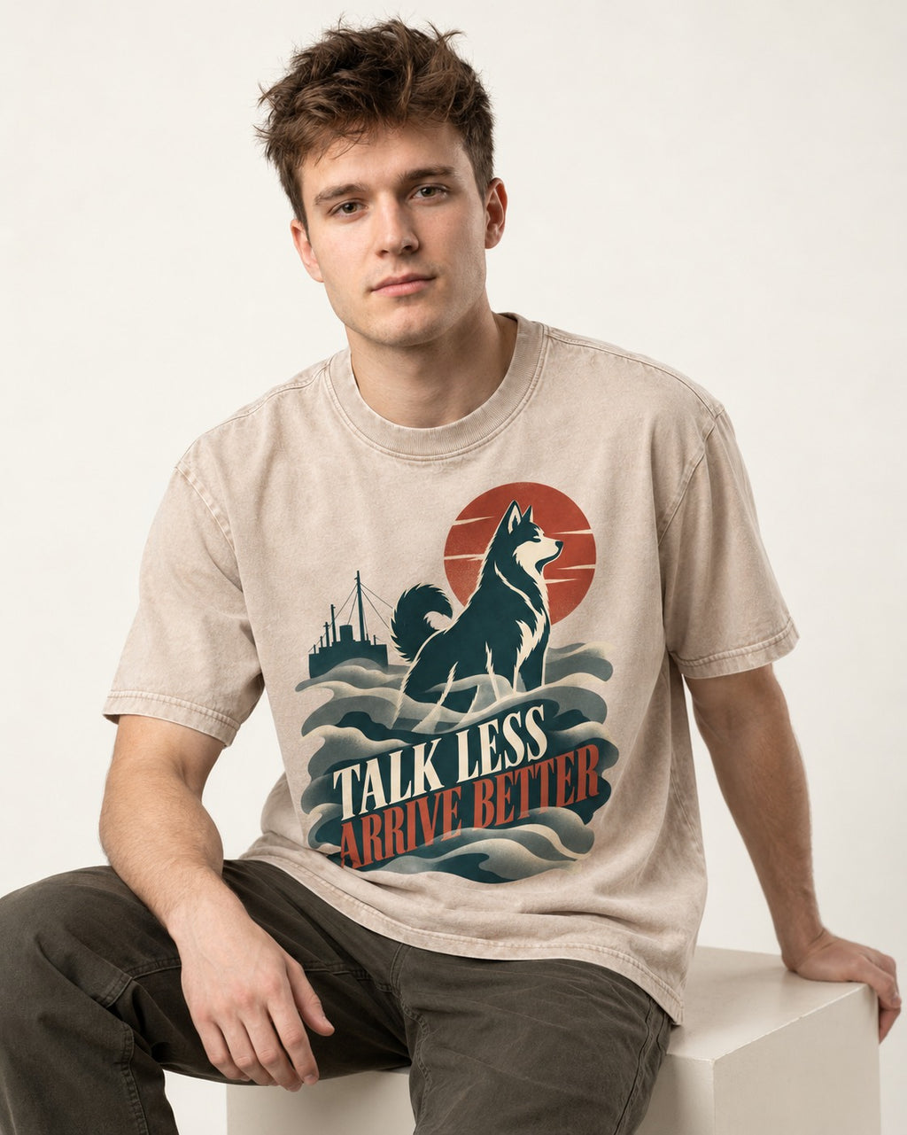 Husky Talk Less Arrive Better Harbor Wave Graphic Washed Tee in Apricot, worn by a seated model