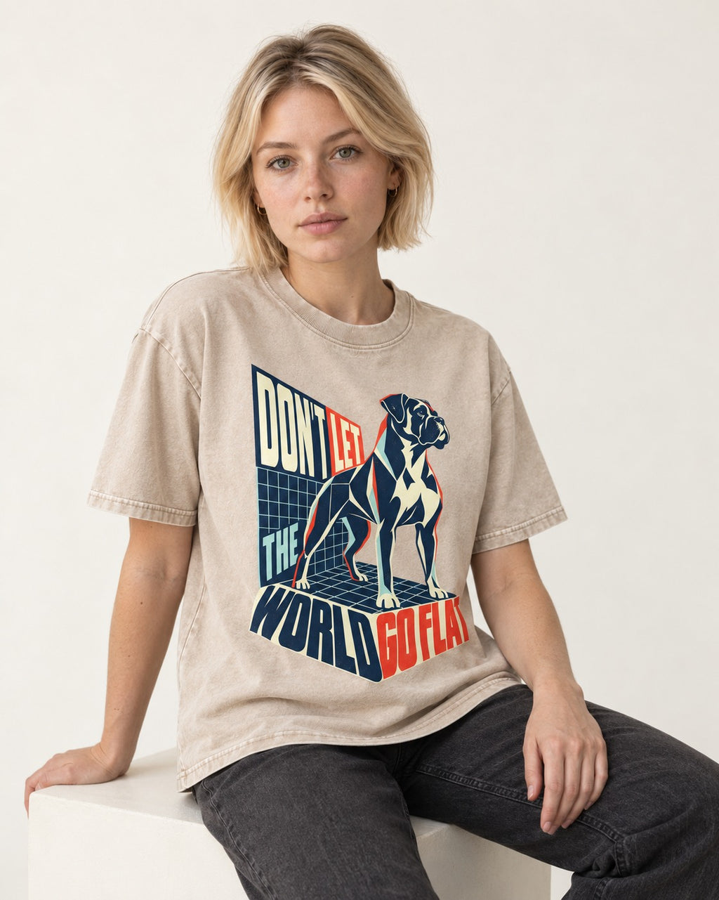 Don't Let the World Go Flat Boxer Perspective Grid Graphic Washed Tee in Apricot, worn by a seated model