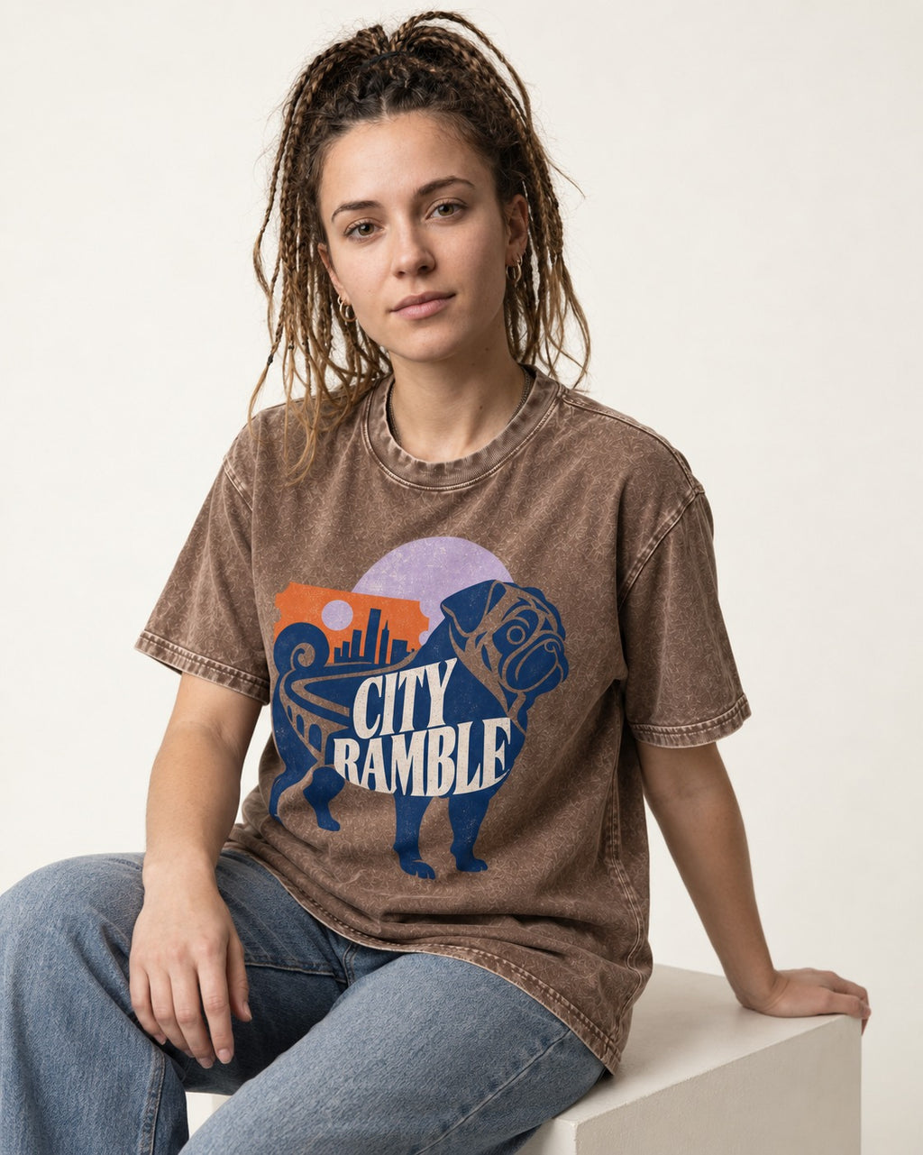 Pug's Big City Ramble Washed Tee in Coffee, worn by a seated model