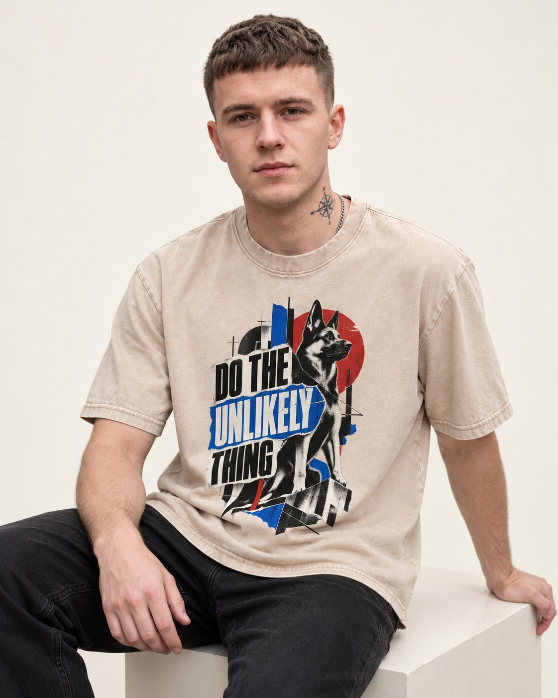 Do The Unlikely Thing Torn Poster German Shepherd Dog Graphic Washed Tee in Apricot, worn by a seated model