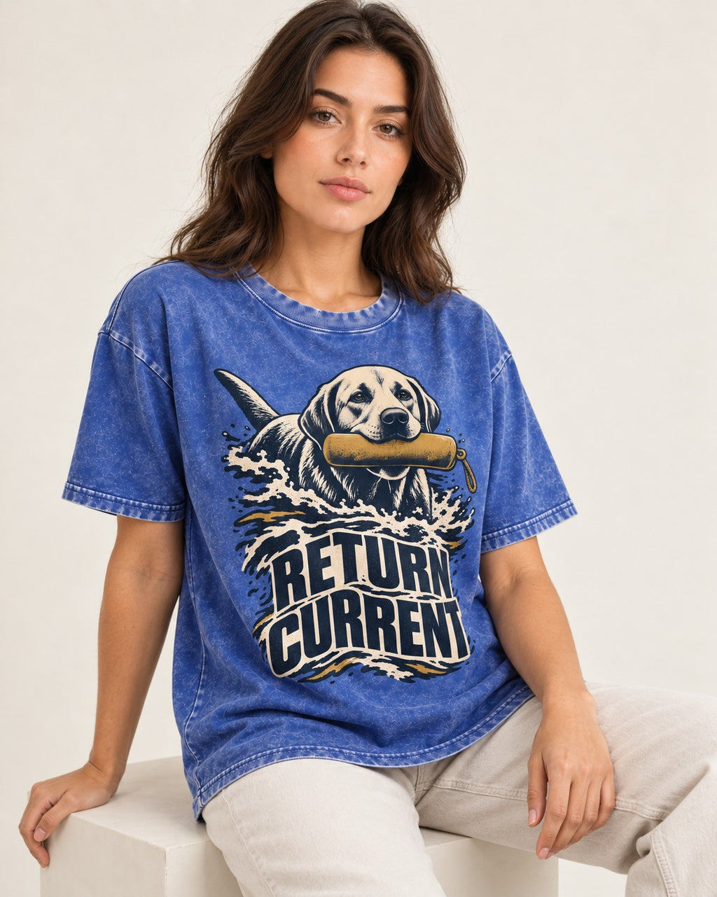 Return Current Water Retrieve Labrador Retriever Graphic Washed Tee in Royal Blue, worn by a seated model