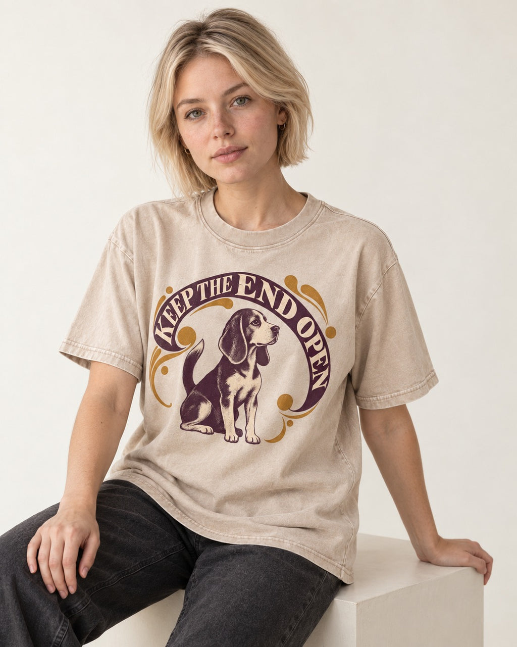 Beagle Keep The End Open Ornamental Graphic Washed Tee in Apricot, worn by a seated model