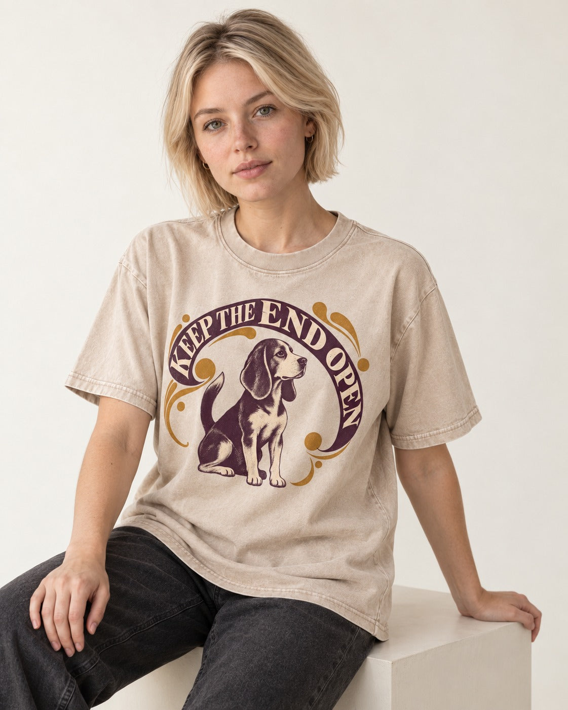 Beagle Keep The End Open Ornamental Graphic Washed Tee in Apricot, worn by a seated model