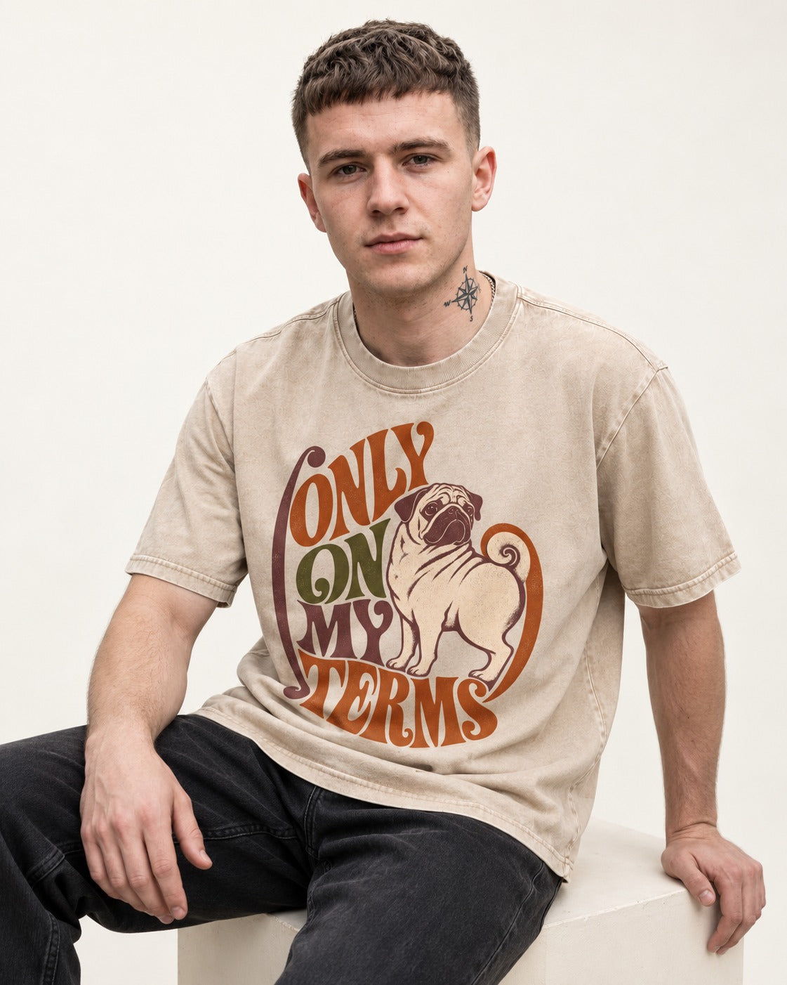 Pug Only on My Terms Washed Tee in Apricot, worn by a seated model