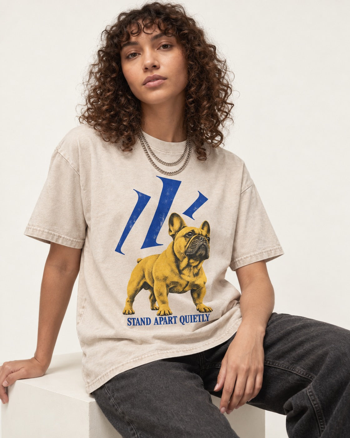 Frenchie Stand Apart Quietly Washed Tee in Apricot, worn by a seated model