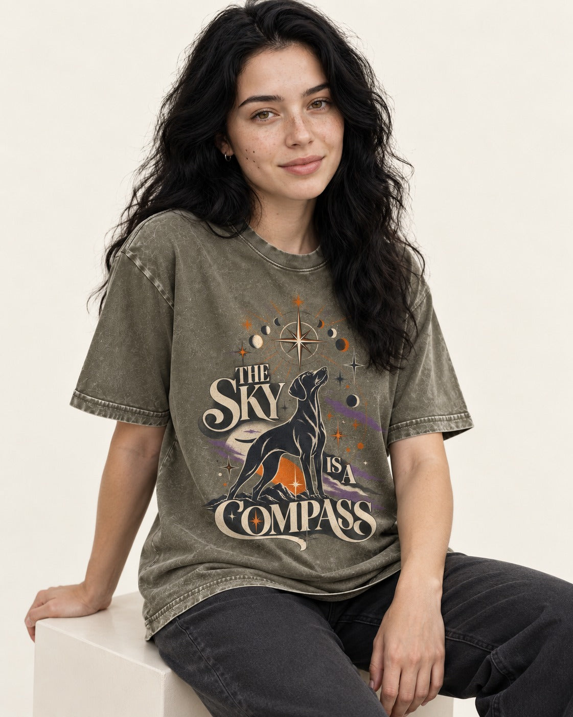 The Sky Is a Compass Celestial German Shorthaired Pointer Graphic Washed Tee in Army Green, worn by a seated model