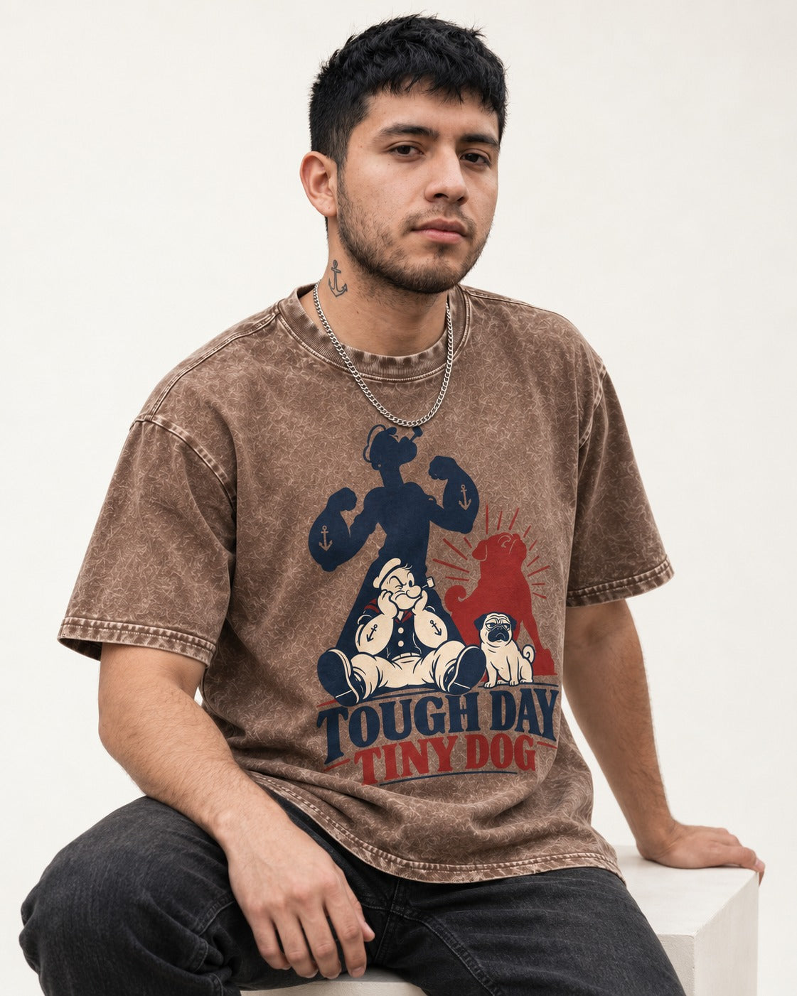 Tough Day Tiny Pug Washed Tee in Coffee, worn by a seated model