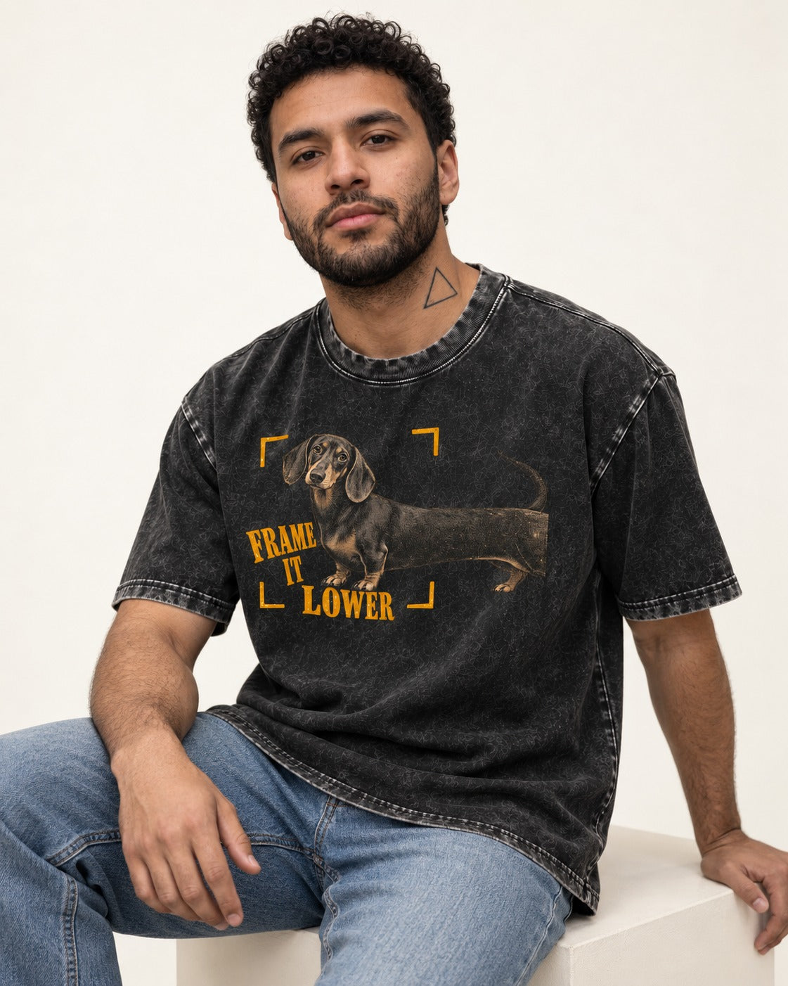 Dachshund Frame It Lower Viewfinder Graphic Washed Tee in Black, worn by a seated model