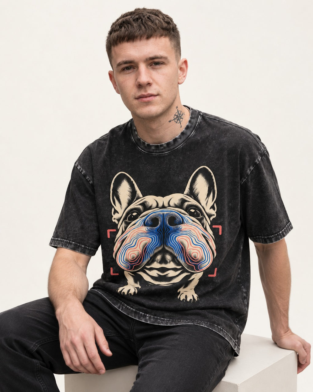 Frenchie Nose Topography Graphic Washed Tee in Black, worn by a seated model