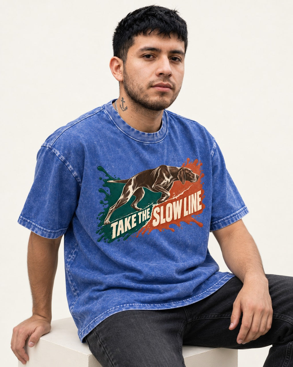 German Shorthaired Pointer Take The Slow Line Paint Splash Graphic Washed Tee in Royal Blue, worn by a seated model