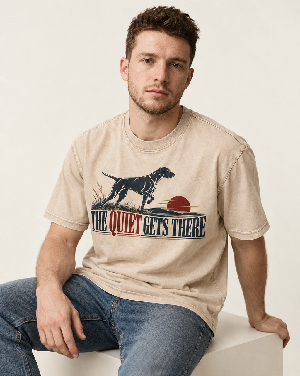 The Quiet Gets There German Shorthaired Pointer Washed Tee in Apricot, worn by a seated model