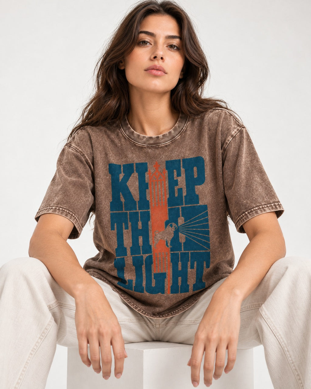 Keep the Pug Fight Washed Tee in Coffee, worn by a seated model