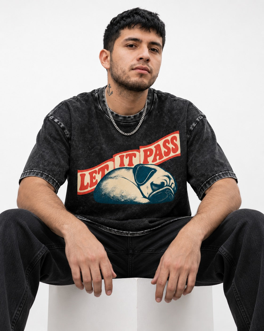 Pug Let It Pass Sleeping Banner Graphic Washed Tee in Black, worn by a seated model