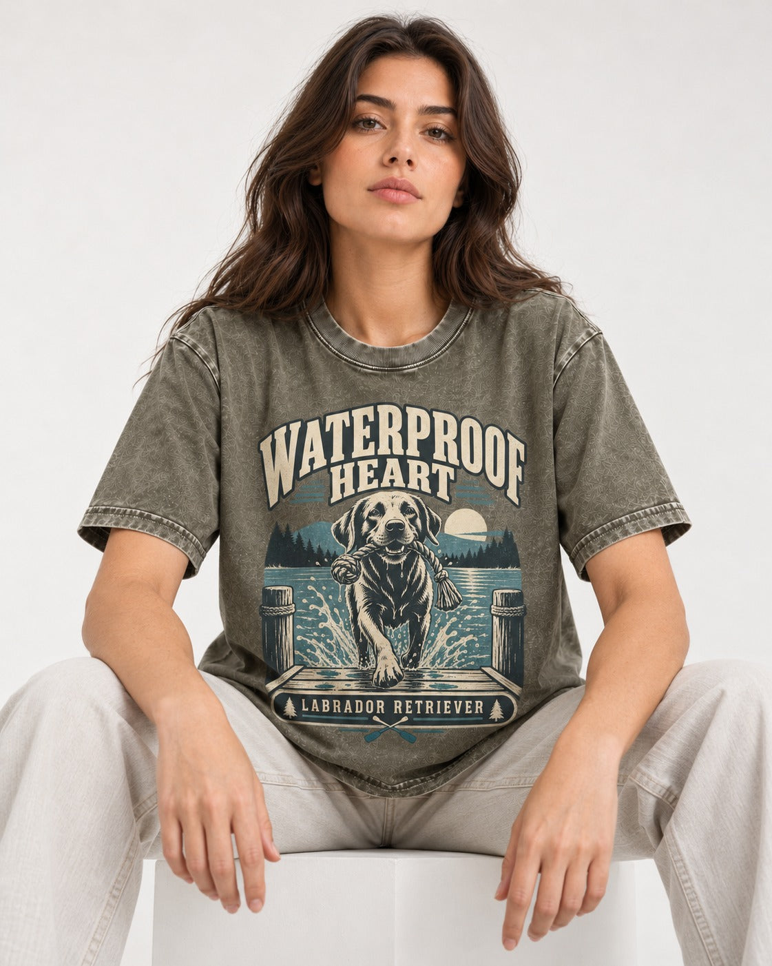 Labrador Retriever Waterproof Heart Lake Adventure Graphic Washed Tee in Army Green, worn by a seated model