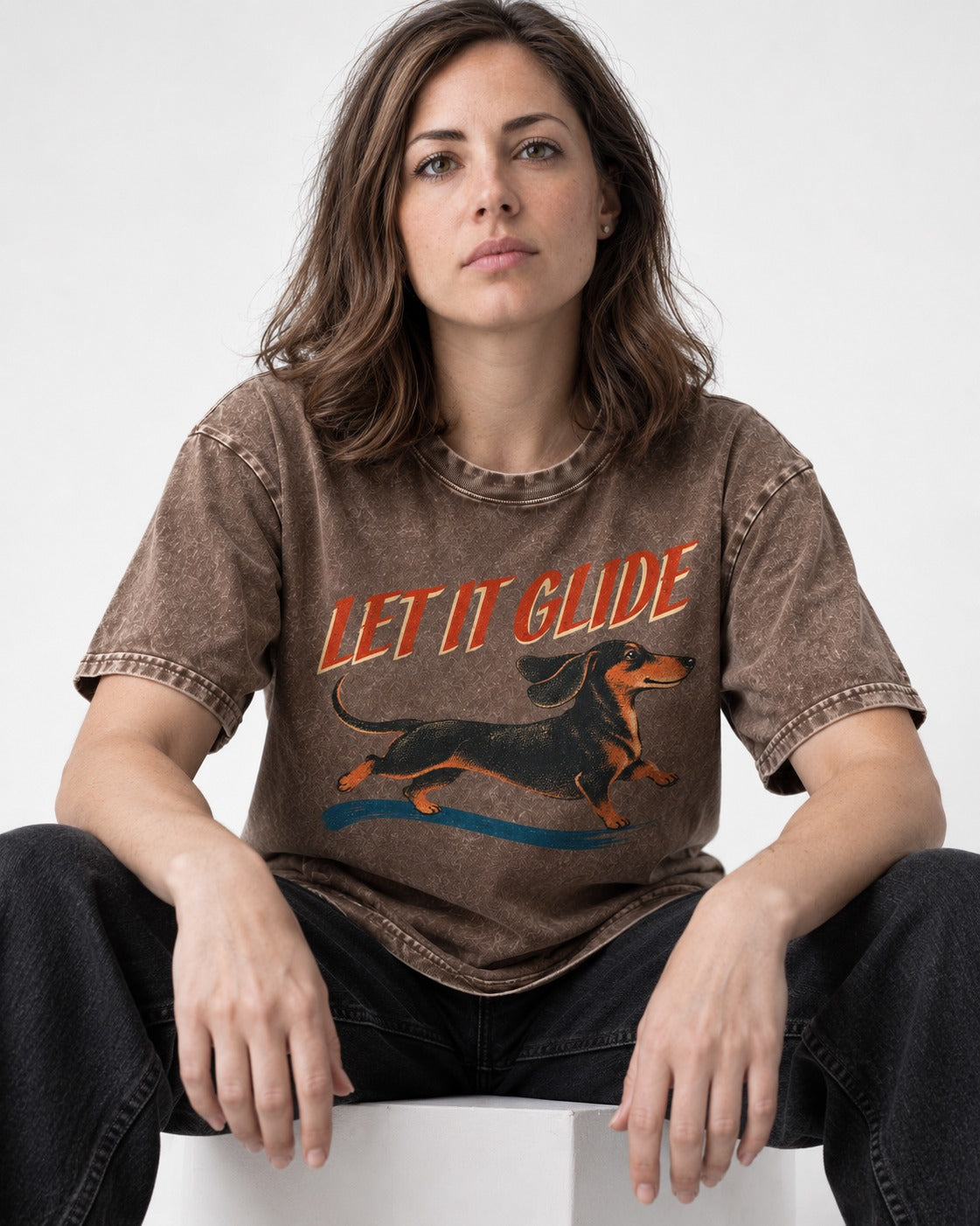Let It Glide Dachshund Washed Tee in Coffee, worn by a seated model
