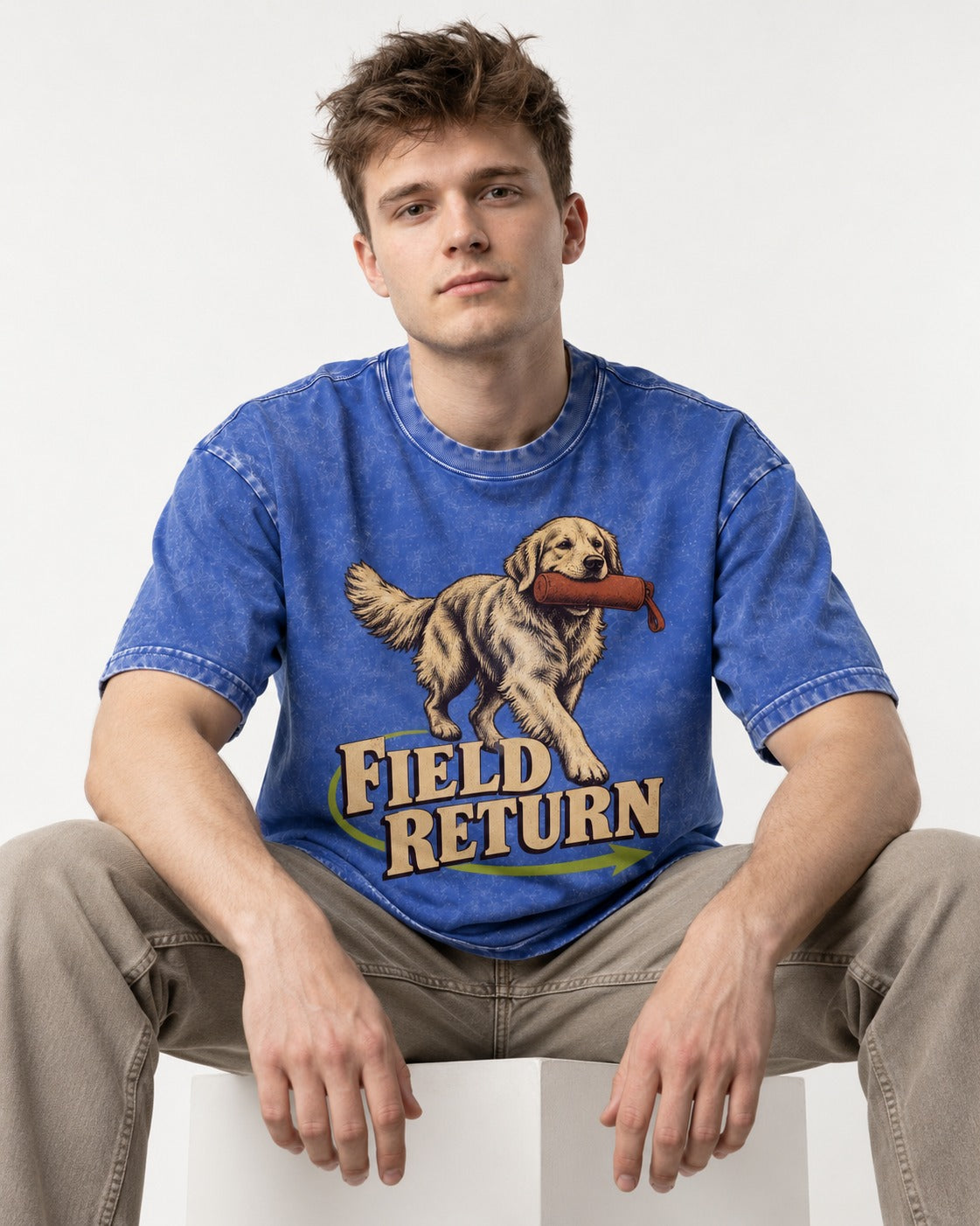 Golden Retriever Field Return Training Dummy Graphic Washed Tee in Royal Blue, worn by a seated model